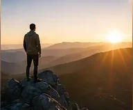 Person overlooking a sunrise representing hope and resilience during Stage 4 cancer care